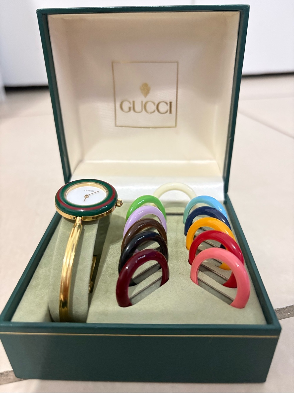 Gucci Gold-Tone Bangle Watch with Multicolor Interchangeable Bezels